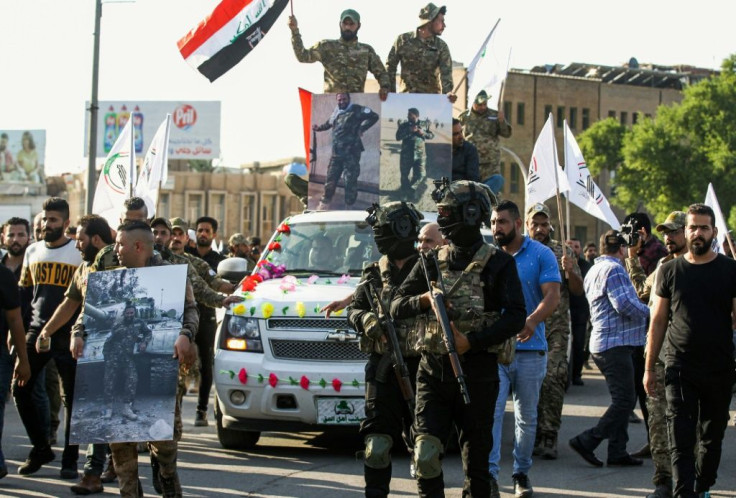 Members of the Hashed al-Shaabi paramilitary force take part in a funerary procession in the Iraqi capital Baghdad