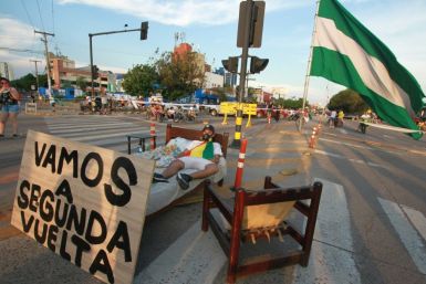 A supporter of Bolivian opposition candidate Carlos Mesa blocks an avenue in Santa Cruz, Bolivia, as a protest against election results confirming President Evo Morales as the winner