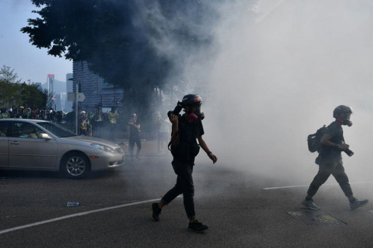 Clouds of acrid smoke wafted across streets usually packed with tourists, including outside the landmark colonial-era Peninsula Hotel, as protesters and police clashed