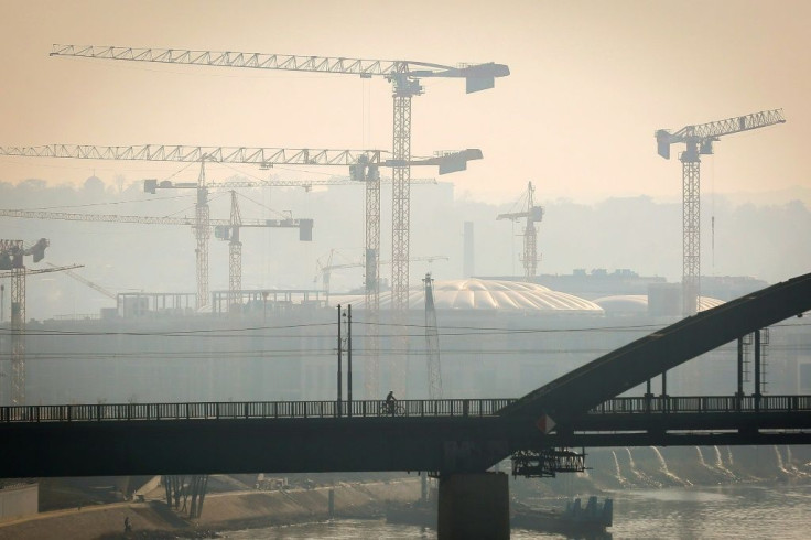A man rides a bicycle on one of Belgrade's bridges on October 27, 2019. Serbian health authorities warned on October 27, 2019, against "very high" air pollution in Belgrade and several other cities in the country, a situation that has persisted for severa