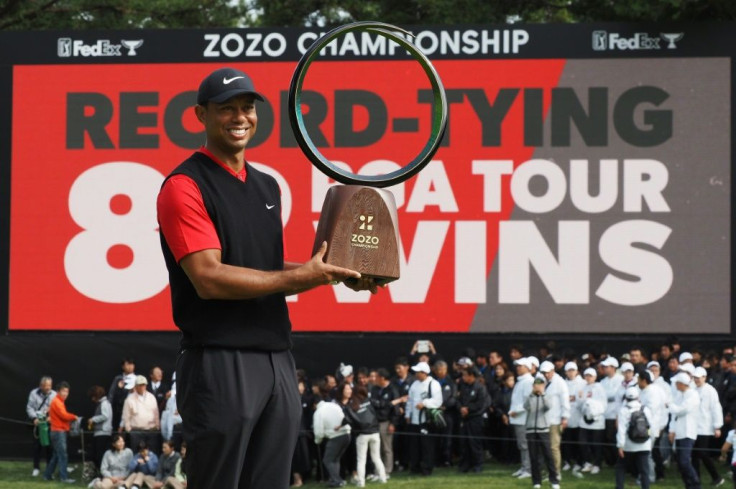 Tiger Woods of the US holds a the trophy after winning the US PGA Tour's Zozo Championship in Japan