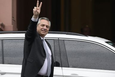 Argentina's president-elect Alberto Fernandez flashes de "V" sign as he leaves the Casa Rosada presidential palace after a meeting with President Mauricio Macri