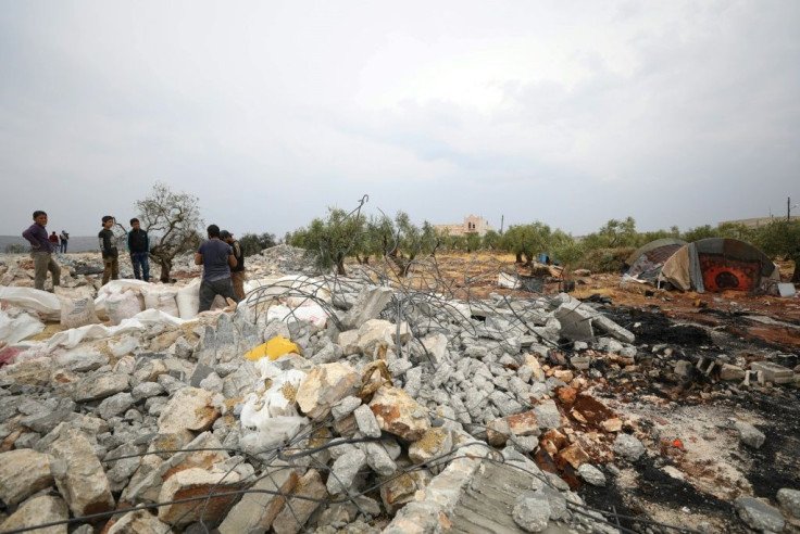 Syrians sifting through the rubble at the site of a US-led operation against Islamic State group chief Abu Bakr al-Baghdadi on the edge of the small Syrian village of Barisha in Idlib province