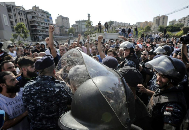 Riot police deployed after counter-demonstrators wielding sticks and throwing stones attacked the Beirut protest site