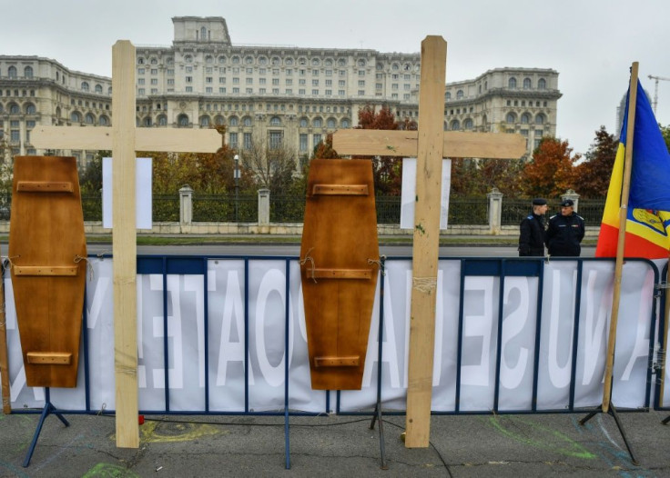 Wooden crosses in tribute to the "forest rangers heroes" honouring the killed forest guards are pictured in front of the Romanian Parliament during a protest in Bucharest