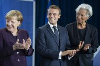 New ECB head Christine Lagarde (right) wants Germany Chancellor Angela Merkel (left) to increase public spending to give the sluggish European economy a boost, a move supported by French President Emmanuel Macon (centre)