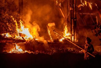 A firefighter battles the Kincade fire off Highway 128, east of Healdsburg, California