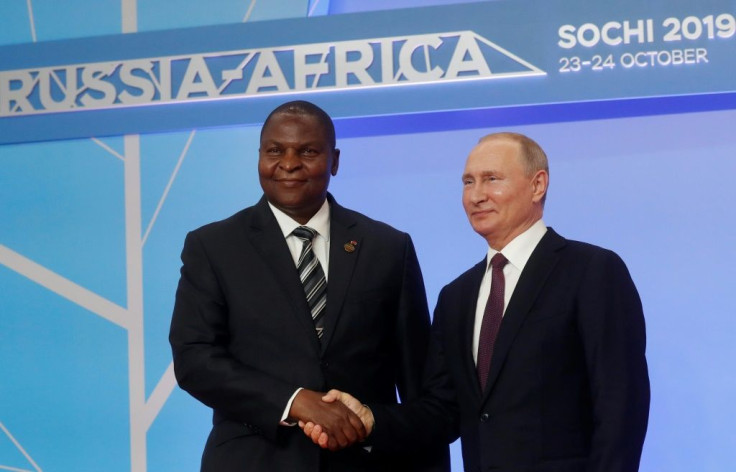 Russian President Vladimir Putin is seen here with Central African President Faustin Archangel Touadera; an investigation of a disinformation campaign on Facebook has linked the effort to Yevgeny Prigozhin, a key ally of the Russian leader