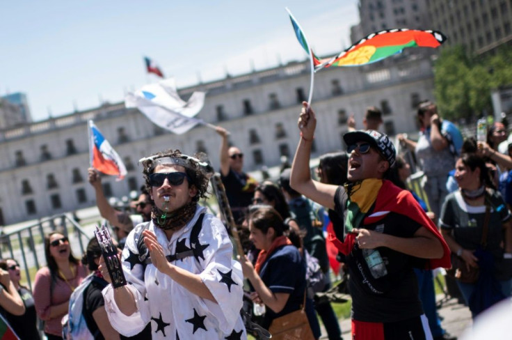 People demonstrate against the government economic policies in front of La Moneda presidential palace in Santiago, on October 30, 2019