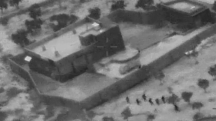 This still image from a video released by the US Department of Defense shows US forces (lower R) advancing on the compound of Islamic State group leader Abu Bakr al-Baghdadi in Syria