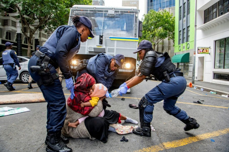 Police fired water guns and stun grenades to disperse the asylum-seekers staging a sit-in protest in the UN's Cape Town office