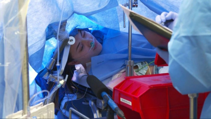 In this October 29, 2019, still image taken from a video courtesy of Methodist Dallas Medical Center in Dallas, Texas, Jenna Schardt, 25, remains conscious while neurosurgeons perform brain surgery