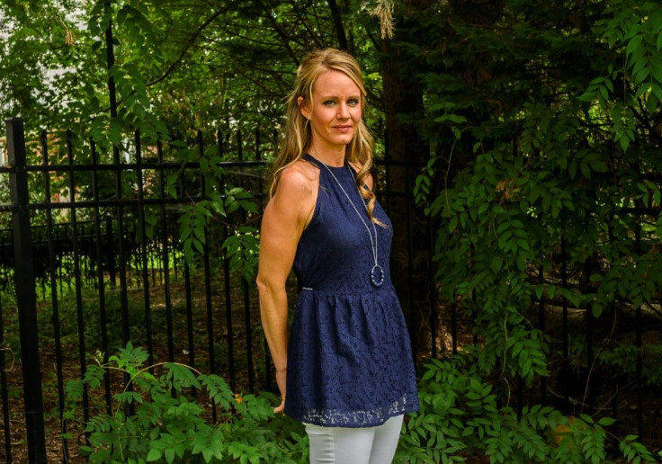 Columbine shooting survivor Kacey Ruegsegger Johnson poses for a photo in her backyard in Raleigh, North Carolina -- revealing her reconstructed right shoulder and arm