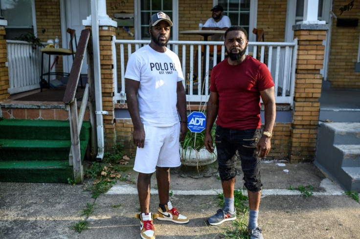 Baltimore resident and gunshot survivor Antonio Pinder (L) gets much needed support from his uncle and best friend Lamont Medley (R)