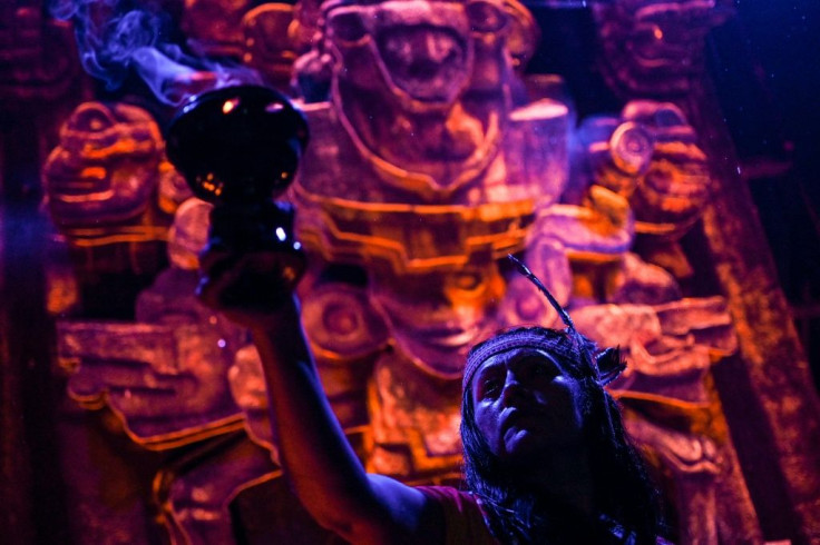 Actors perfom in front of an altar dedicated to the underworld at the "Gran Ofrenda" (Mega Offering) installed in the Chapultepec Forest in Mexico City, for Day of the Dead
