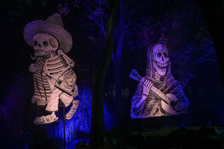Skeletons are portrayed around the "Gran Ofrenda" (Mega Offering) in the Chapultepec Forest in Mexico City
