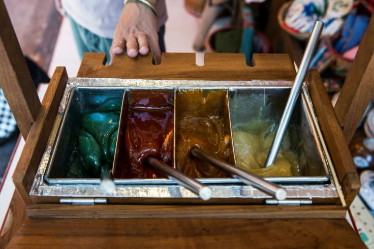 To uses different coloured sugar mixtures to decorate his candy