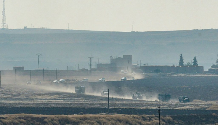 A convoy of Russian and Turkish military vehicles snakes its way along the Syrian side of border in the first joint patrol of a buffer zone set up under an agreement struck by Ankara and Moscow last week