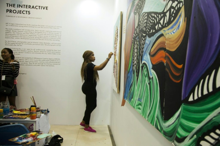 Nigerian artist Queen Nwaneri paints during the Art X event in Lagos