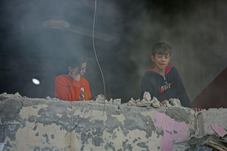 Children on a damaged balcony above the site of a car bomb explosion that took place Saturday in the northern Syrian town of Tal Abyad