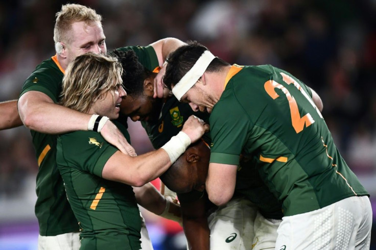 South Africa's Makazole Mapimpi (C) is congratulated by teammates after scoring a try during the Japan 2019 Rugby World Cup final against England