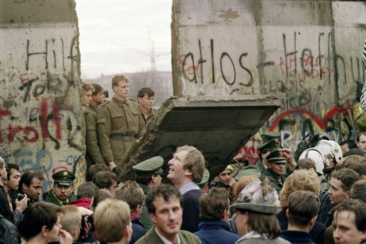 The Berlin Wall comes down in November 1989, with some East German border guards demolishing one section