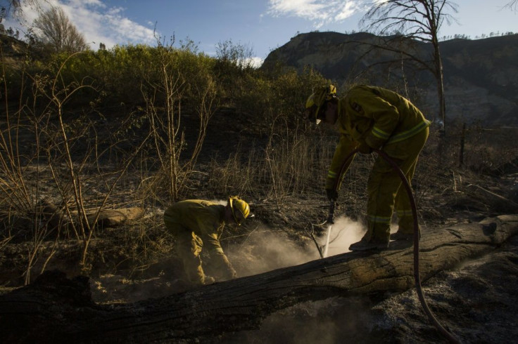 Firefighters hosing down hotspots of the Maria Fire, in Ventura County, California