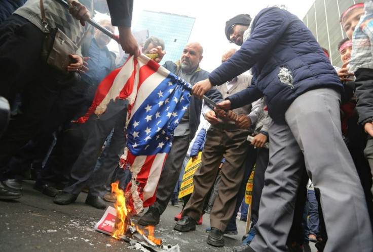 Iranians set fire to the US flag outside the former American embassy in Tehran
