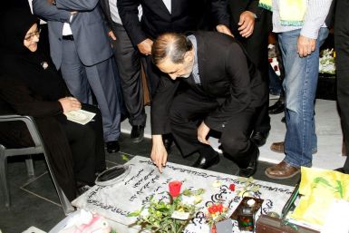 Ali Akbar Velayati, who has been slapped with sanctions by the United States and serves an adviser to Iran's supreme leader Ayatollah Ali Khamenei, prays over the tomb of a Hezbollah fighter at a cemetery in Beirut's southern suburbs in May 2015