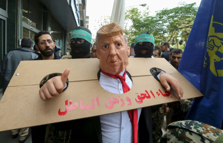 An Iranian protester dressed as US president Donald Trump in a pillory takes part in a rally outside the former US embassy in the capital Tehran on November 4, 2019, to mark the 40th anniversary of the Iran hostage crisis