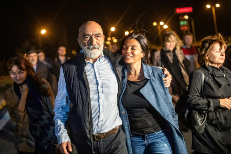 Turkish journalist and writer Ahmet Altan walks with his daughter Sanem Altan after being released from prison