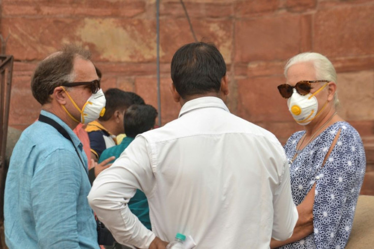 Some foreign tourists wore face masks while visiting the famed Taj Mahal in Agra as smog levels soared