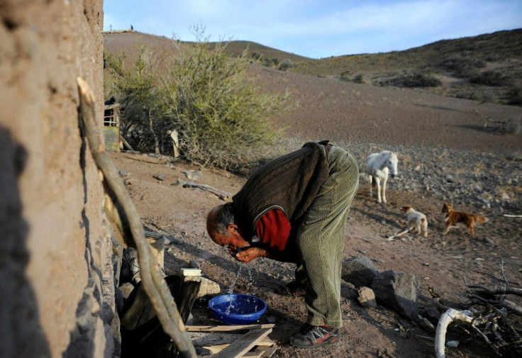 Antonio Sazo washes his face outside his house in El Alambrado