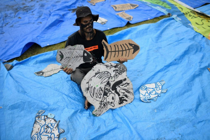 An activist in Rio de Janeiro protests against Brazil's government auction for offshore oil fields