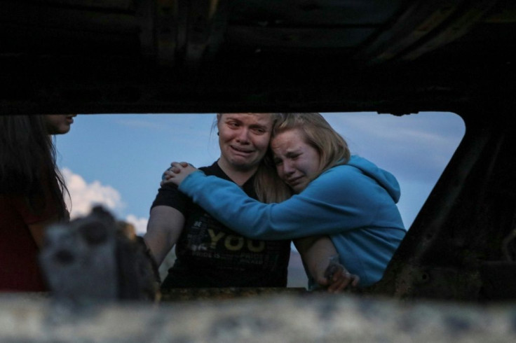 Members of the LeBaron family mourn at the site of an attack in Sonora, Mexico where nine women and children were killed