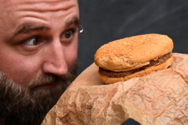 Casey Dean inspects a McDonald's burger he bought in 1995 with friend Eduards Nits and kept in an Australian shed for years