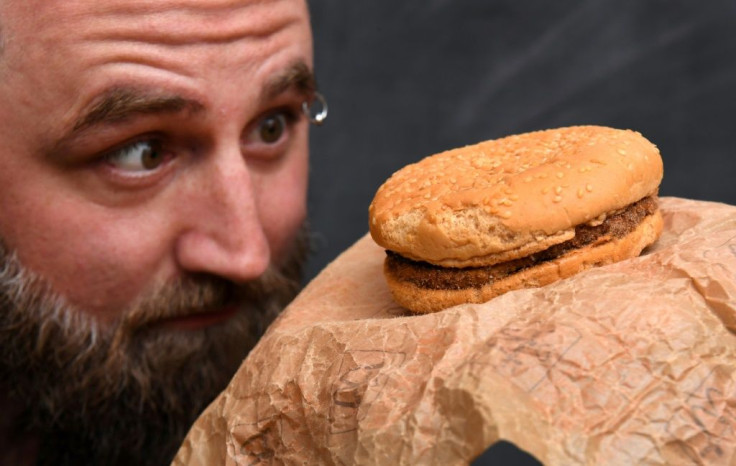Casey Dean inspects a McDonald's burger he bought in 1995 with friend Eduards Nits and kept in an Australian shed for years