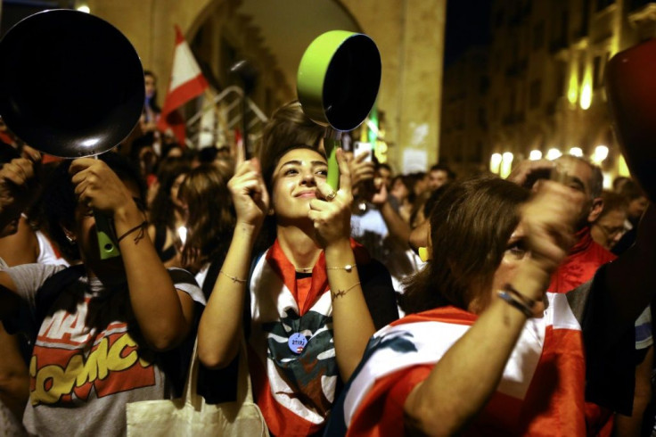 Women protesters in Beirut's central Martyrs Square bang on pots and pans, creating a commotion that spread to homes across the capital