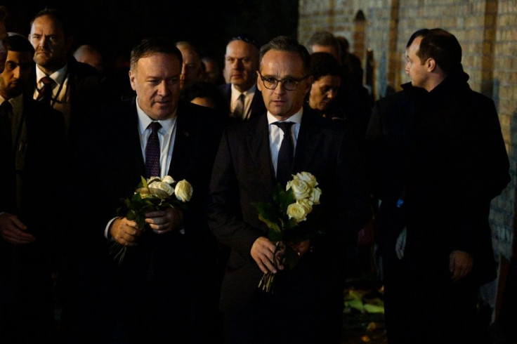Accompanied by Germany's Foreign Minister Heiko Maas (C), Pompeo left flowers to mark last month's fatal shooting by a far-right gunman