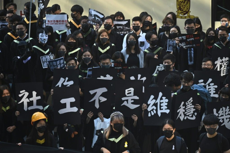 Masked university students protest against Chin's rule of Hong Kong at their graduation ceremony