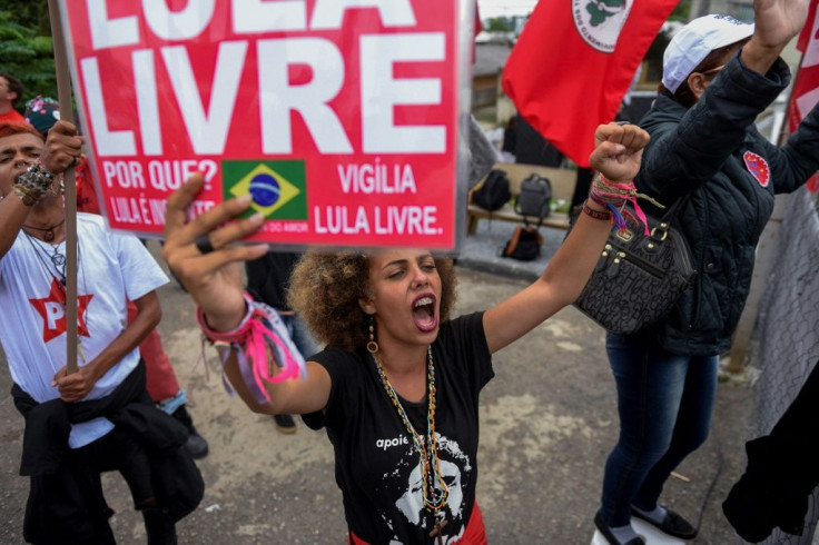 Supporters of former Brazilian President Luiz Inacio Lula da Silva celebrate a Supreme Court ruling that could benefit him, in front of the police headquarters where he is jailed in Curitiba on November 8, 2019