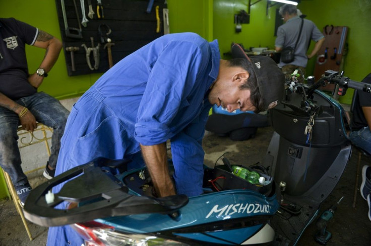 Mechanics have work to do servicing Cuba's fleet of electric motorcycles