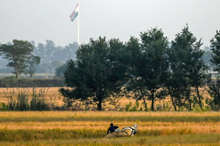 The Indian flag could be seen flying across the border, just beyond fields dotted with eucalyptus and guava trees