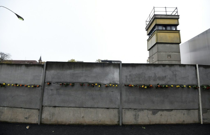 Flowers lining a section of the Berlin Wall that still stands, 30 years on