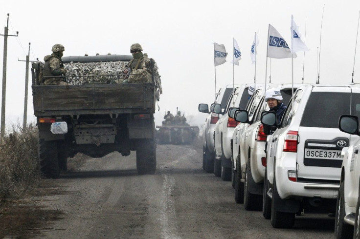 Ukrainian troops withdraw from conflict-riven Donetsk on Saturday, watched by OSCE monitors