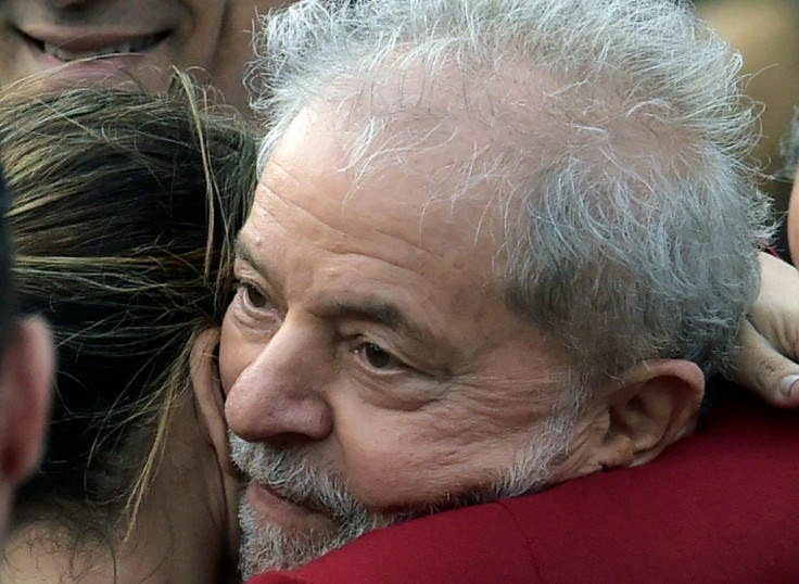 Former Brazilian President Luiz Inacio Lula da Silva embraces a woman as he leaves prison