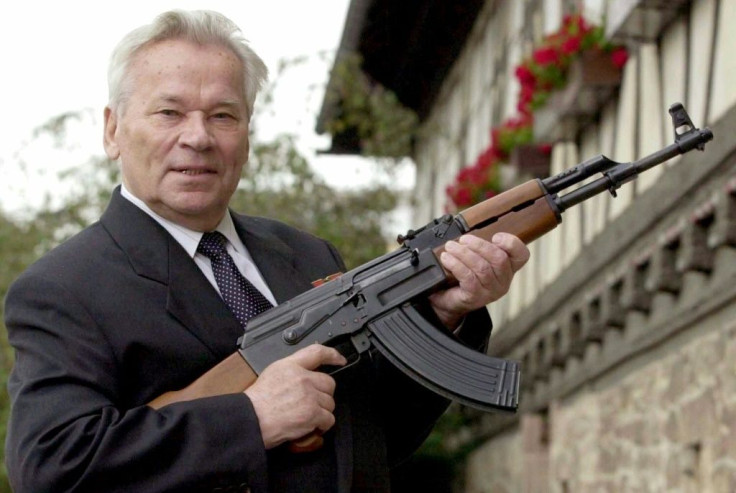 ussian general Mikhail Kalashnikov poses with his famous assault rifle in 2002
