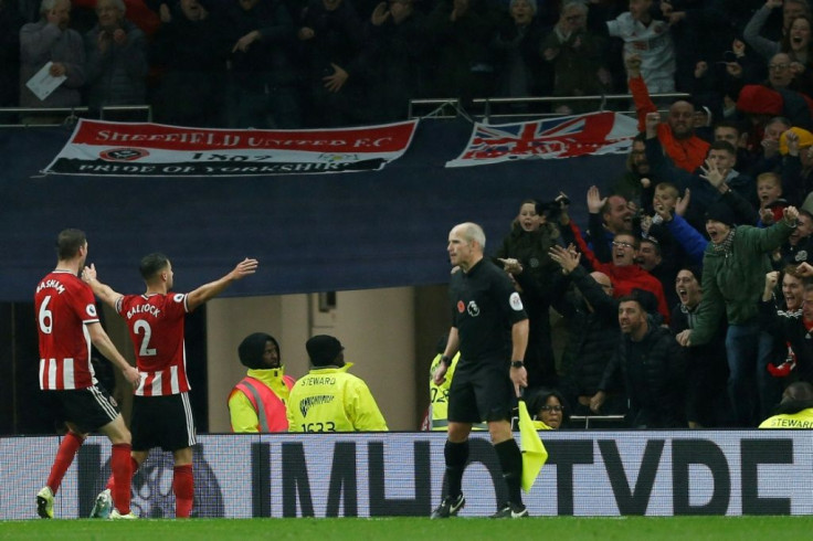 Buoyant Blades: George Baldock celebrates Sheffield United's equaliser at Tottenham