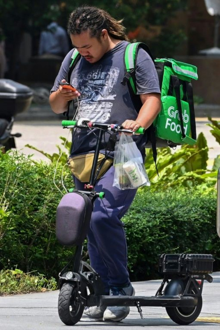 Singapore's transport ministry says the government and companies are offering grants for e-scooter delivery riders to switch to other devices including regular and power-assisted bicycles