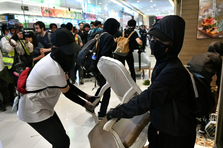 Hong Kong activists and police have clashed in multiple neighbourhoods after protesters held flashmob protests and vandalism sprees inside malls